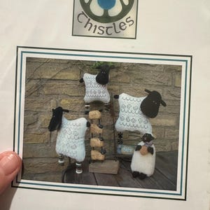 May include: A set of three ceramic mugs with a speckled, matte finish. The mugs are in cream, light grey, and dark grey. Each mug has a simple, minimalist design, ideal for coffee or tea.