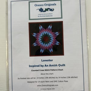 May include: A cross-stitch pattern chart titled "Lonestar," inspired by an Amish quilt design. The chart features a star design in shades of red, blue, and green. The finished size will be 14 inches by 14 inches.