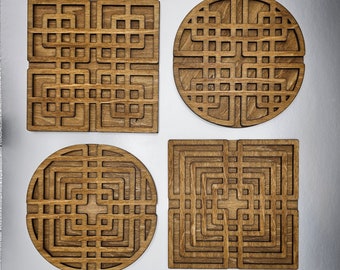 May include: Four wooden coasters with intricate geometric designs. The coasters are square and round in shape and feature a dark brown wood finish.