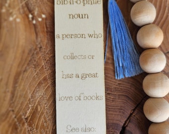 May include: Wooden bookmark with a blue tassel, featuring the definition of "bibliophile" and the word "Marlee".