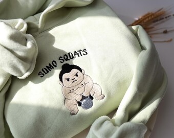 Sudadera y sudadera con capucha bordada con sentadillas de sumo - Unisex