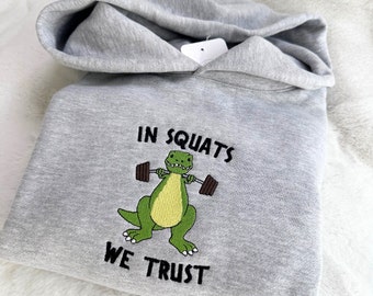 T-Rex en sentadillas confiamos en sudadera con capucha bordada - Unisex