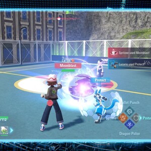 May include: A screenshot from a video game featuring a battle scene. A character in a brown jacket and hat is using Moonblast. A blue and white creature is in front of the character. The game interface displays health bars and attack options.