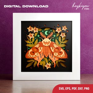 May include: A framed paper cut design featuring a moth with intricate details in shades of orange, brown, and cream. The design includes stars, leaves, and a crescent moon. The words "DIGITAL DOWNLOAD" are at the top, and "SVG, EPS, PDF, DXF, PNG" are at the bottom.