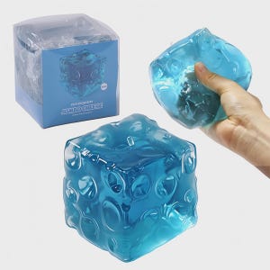 May include: A translucent blue stress ball in a cube shape, resembling cheese. The image shows the stress ball in its packaging and being held. The box features the text "FUFUSQUISHY JUMBO CHEESE".