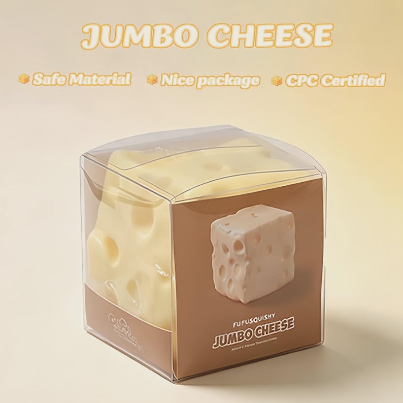 May include: A jumbo cheese-shaped toy in a clear plastic box. The toy is light yellow with holes, resembling Swiss cheese. The box has brown sides with the text "JUMBO CHEESE" and "FUFUSQUISHY".
