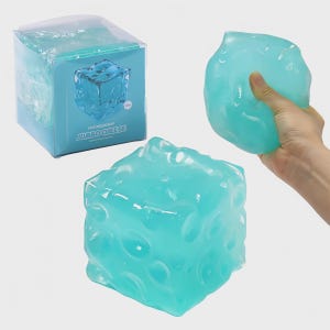 May include: A light blue, cube-shaped stress ball with a textured surface, resembling a block of cheese. The packaging reads "FUFUSQUISHY JUMBO CHEESE". One is held in a hand, and another is on display.