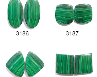 May include: Four pairs of green malachite cabochons, each pair is a different shape: oval, square, triangle, and rectangle. The cabochons are all polished and have a smooth surface. The cabochons are labeled with numbers 3186, 3187, 3188, and 3189.