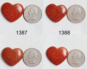 May include: Four heart-shaped red sandstone cabochons, each about the size of a US quarter.