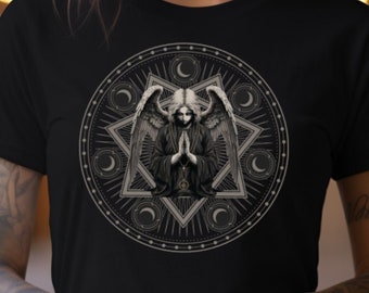 May include: A black t-shirt with a graphic print of a woman with wings in a geometric design. The design is in shades of gray and white.
