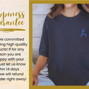 May include: Dark gray t-shirt with a blue ribbon design on the chest. The image also includes text that says "Happiness Guarantee" and a commitment to high-quality products with a refund policy.