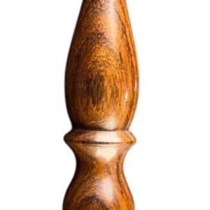 May include: A handcrafted crochet hook made of wood. The hook features a curved tip and a detailed, textured handle with a warm, brown color. The handle has a bulbous shape with a series of rounded sections.