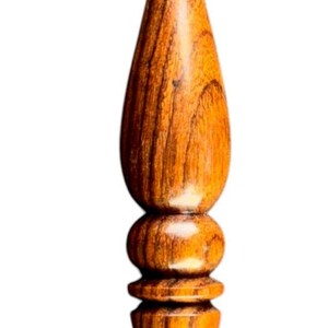 May include: A handcrafted wooden crochet hook with a polished finish. The hook features a rounded handle with a series of decorative rings and a tapered, curved hook end. The wood grain is visible, showcasing the natural color variations.