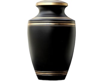 May include: Black urn with gold trim. The urn has a rounded top and a wide base.