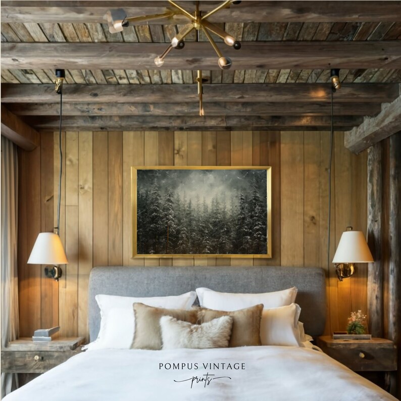 May include: A bedroom with a wooden wall and a large framed painting of a snowy forest. The bed has a gray headboard and white bedding with brown and white pillows. There are two bedside tables with lamps and a gold chandelier hanging from the ceiling.