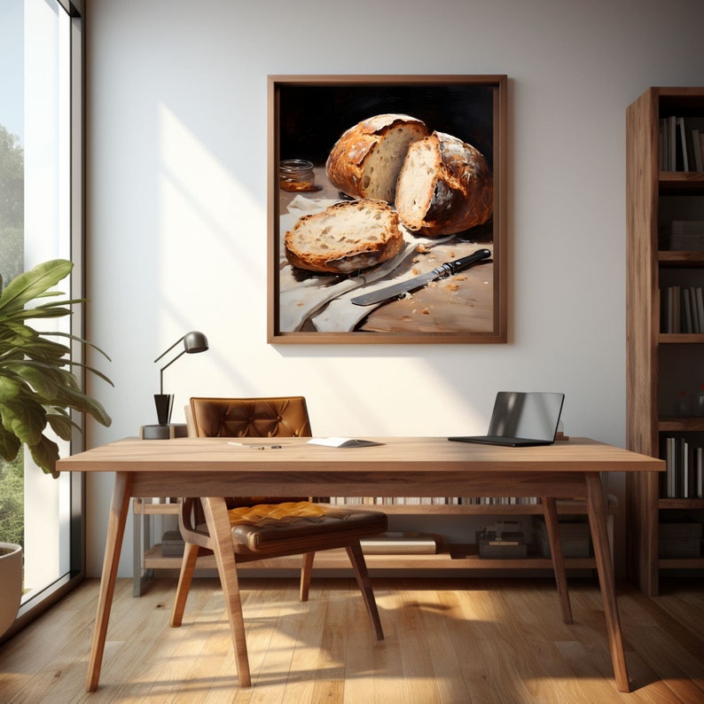 May include: A painting of a loaf of bread sliced in half, with a knife and a jar of honey on a wooden table. The painting is framed in a dark wood frame.