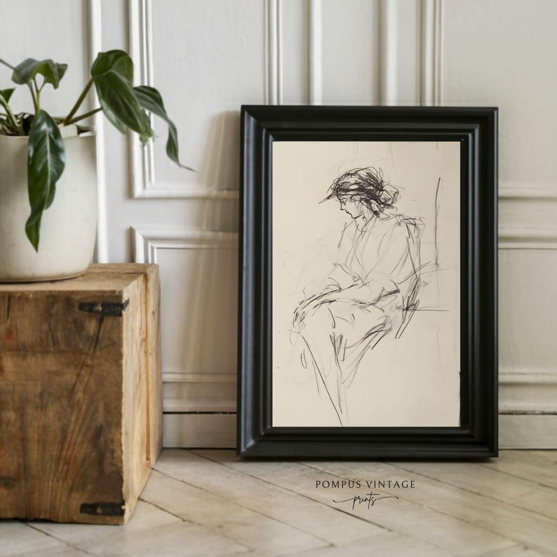 May include: Black and white line drawing of a person sitting in a chair, framed in a black frame. The drawing is on a cream-colored background. The text "POMPUS VINTAGE prints" is at the bottom of the image.