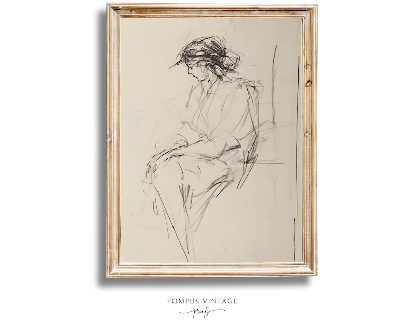 May include: A black and white line drawing of a person sitting in a chair. The drawing is framed in a light wood frame.