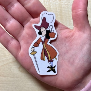 May include: A sticker featuring Captain Hook from Disney's Peter Pan. He is wearing a red and gold coat, a black hat, and a hook for a hand. He is holding a sword and has a mischievous expression on his face.