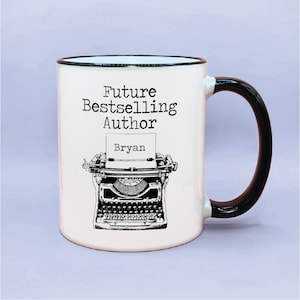May include: White ceramic mug with a black rim and handle. The mug has a black and white illustration of a vintage typewriter with the text "Future Bestselling Author" and the name "Bryan" on the paper.