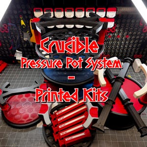 May include: A Crucible Pressure Pot System Printed Kits product image. The image shows a black and red system with the text "Crucible Pressure Pot System Printed Kits". The system has a circular design with various components.