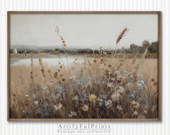 May include: A framed landscape painting featuring a field of tall grasses and wildflowers in muted tones of beige, brown, and blue. The artwork depicts a serene scene with a body of water and distant trees under a cloudy sky. The text "ArtifyFulPrints Vintage art collective" is at the bottom.