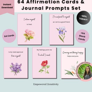 Op de afbeelding: Set van 64 affirmatiecards met bloemillustraties en positieve boodschappen. De kaarten zijn roze met witte tekst en bevatten zinnen als "Ik sta mezelf toe te genezen" en "Ik ben net zo aardig voor mezelf als voor een goede vriend". De set bevat ook 64 blanco kaarten.