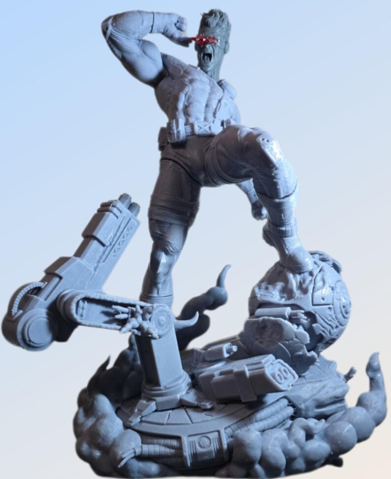 May include: A gray figurine of a muscular character in a dynamic pose, with one arm raised and a red visor over one eye. The figure stands on a detailed base with mechanical elements and a cloud-like effect, suggesting action and power.