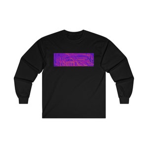 May include: Black long-sleeve shirt with a rectangular design on the chest. The design features a textured, abstract pattern in shades of purple and orange. The shirt has a crew neck and long sleeves.