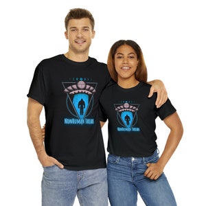 May include: Black t-shirts with a graphic design featuring a UFO, a Bigfoot-like figure, and the text "NONHUMAN THREADS" in blue. The design includes a triangle and moon phases. The models are wearing blue jeans.