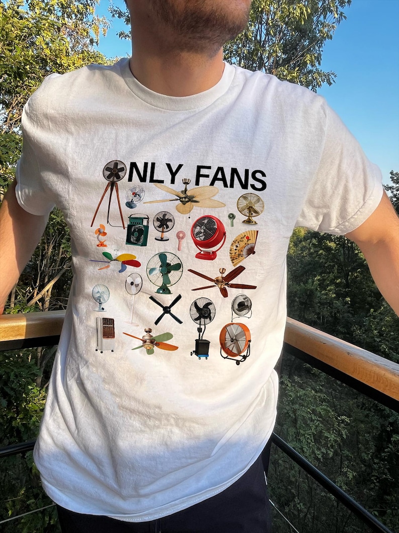 May include: White t-shirt with the text "ONLY FANS" printed in black. The shirt features a design of various types of fans, including ceiling fans, box fans, and stand fans.