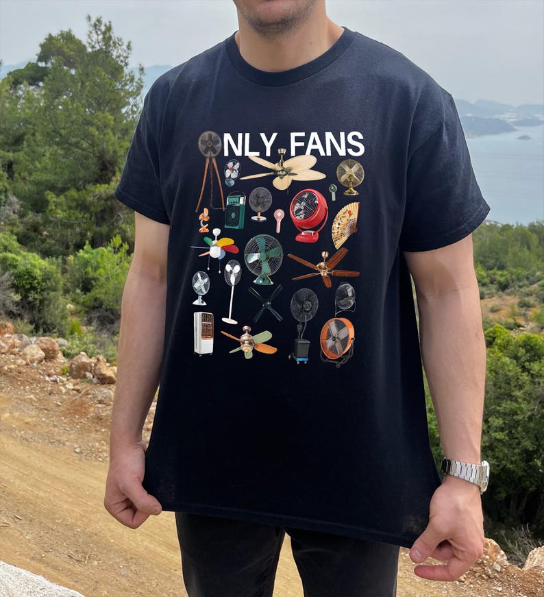 May include: A black t-shirt with the text "ONLY FANS" printed in white. The shirt features a design of various fans, including ceiling fans, box fans, and stand fans.