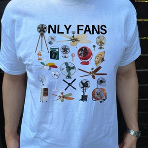 May include: White t-shirt with the text "ONLY FANS" printed in black. The shirt features a design of various types of fans, including ceiling fans, box fans, and stand fans.