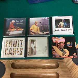 Jimmy Buffett Music CD Set (6) Christmas Island, American Storyteller, Fruit Cakes, Carnival, Coconut Telegraph and JB Live Feeding Frenzy