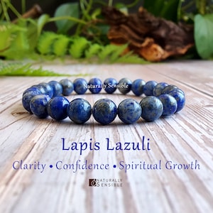 May include: A blue Lapis Lazuli gemstone bracelet with the text "Lapis Lazuli" and "Clarity • Confidence • Spiritual Growth" on a wooden surface. The text "Naturally Sensible" is also visible in the image.