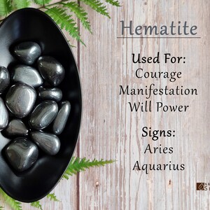 May include: Hematite tumbled stones in a black dish. Hematite is used for courage, manifestation, and willpower. Hematite is associated with the zodiac signs Aries and Aquarius.