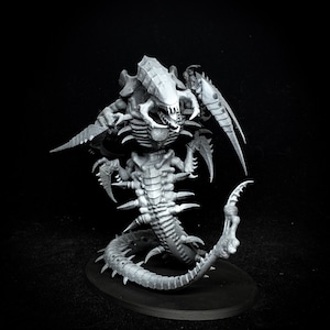 May include: A detailed, gray miniature of a Tyranid creature, featuring a segmented body, multiple limbs with sharp claws, and a large, armored head with menacing teeth. The figure is posed on a black base, showcasing its intricate design.