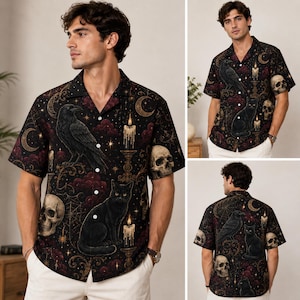 May include: A short-sleeve button-down shirt in black featuring a gothic-inspired print of ravens, black cats, skulls, lit candles, crescent moons, and spiderwebs in shades of gold, red, and dark purple. The shirt has a notched collar.