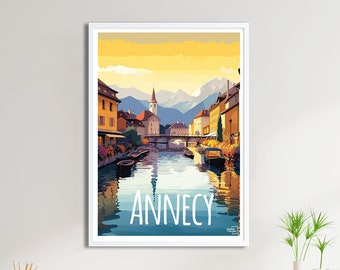 May include: A vintage travel poster featuring a colourful illustration of the city of Annecy, France. The poster depicts a canal with boats, buildings, and a church steeple in the background. The text "Annecy" is written in white letters at the bottom of the poster.