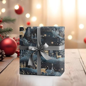 May include: A wrapped gift with a dark blue and gold winter scene design, featuring deer, trees, and houses. The gift is tied with a gray ribbon and bow, creating a festive holiday presentation.