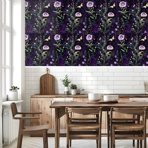 May include: A kitchen with a dining table and chairs. The wall behind the table is covered in wallpaper with a purple floral pattern. The wallpaper features a repeating pattern of purple flowers, butterflies, and green leaves on a black background.