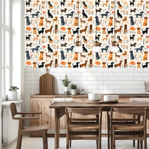 May include: A white kitchen with a wood dining table and chairs. The backsplash features a repeating pattern of various breeds of dogs in different colors and poses.