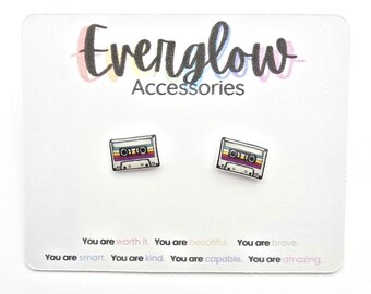 May include: A pair of cassette tape stud earrings on a white card. The earrings are small, rectangular, and feature a colorful design. The card has the text "Everglow Accessories" and inspirational phrases.