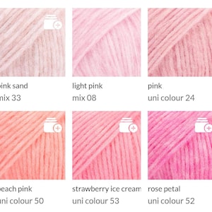 May include: A collection of six skeins of yarn in various shades of pink. The colors range from light pink to a deeper rose, with names like "pink sand," "light pink," and "strawberry ice cream." Each skein is labeled with its color name and number.