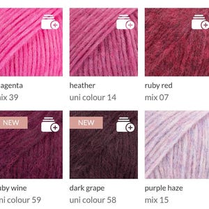 May include: A collection of colorful yarn skeins in various shades of pink, red, and purple. The colors include magenta, heather, ruby red, ruby wine, dark grape, and purple haze. Each skein has a label with the color name and a product code.