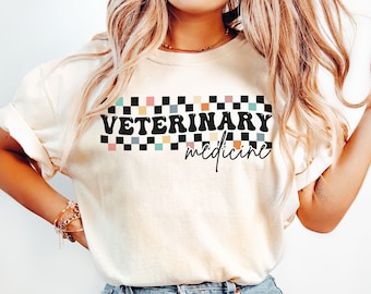 Peut inclure: Un t-shirt blanc avec un motif à carreaux noirs et blancs et le texte "VETERINARY medicine" dans une police rétro.