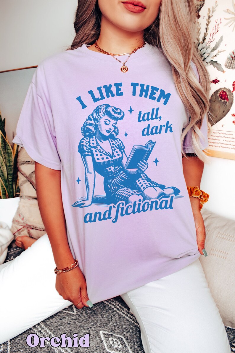 A model wears an orchid shirt that has a retro design all in medium blue that days I like them tall, dark and fictional, with a woman from the 1950s sittings and reading a book.