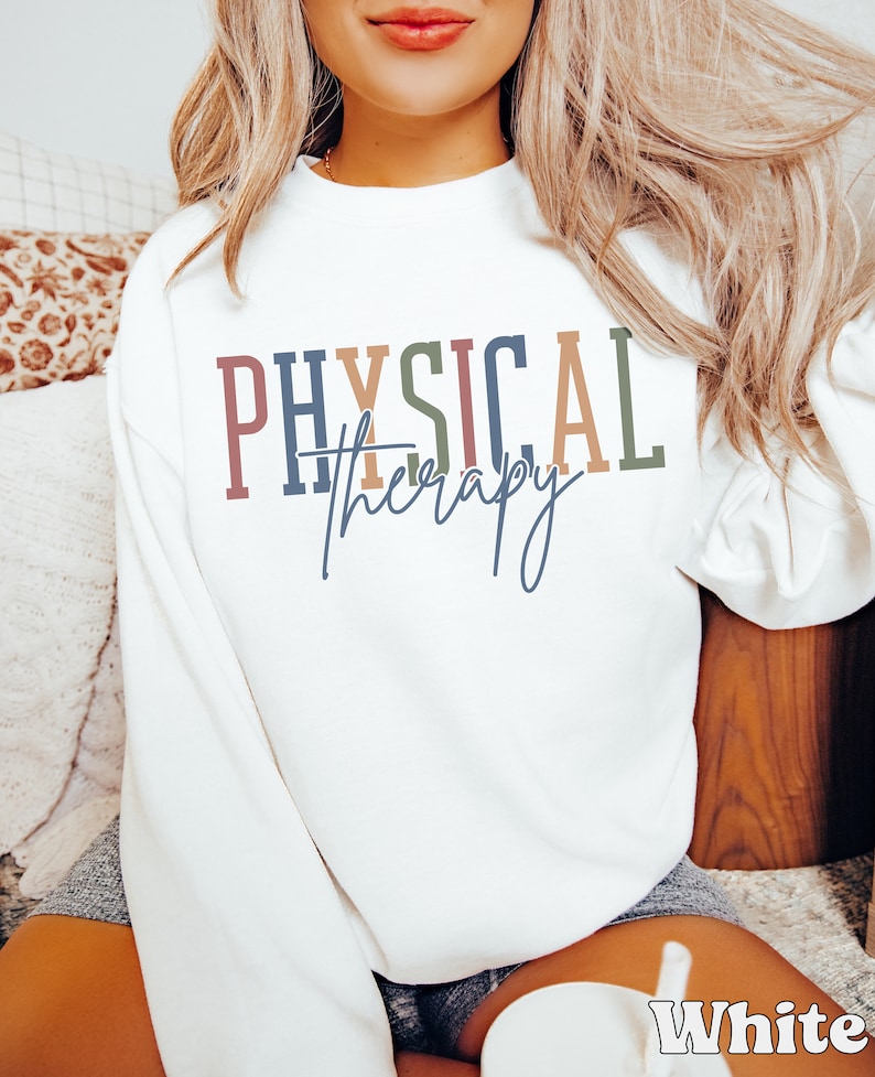 May include: White sweatshirt with the text "PHYSICAL therapy" in colorful letters.