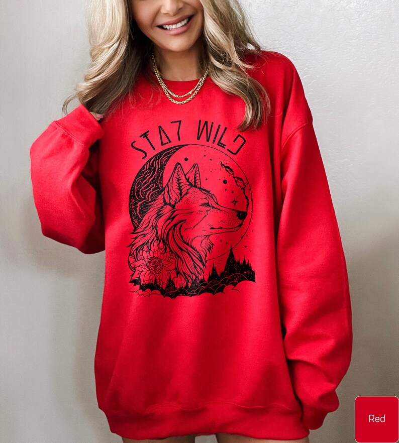 May include: Red sweatshirt with a black wolf design and the text "Stay Wild" printed on the front.