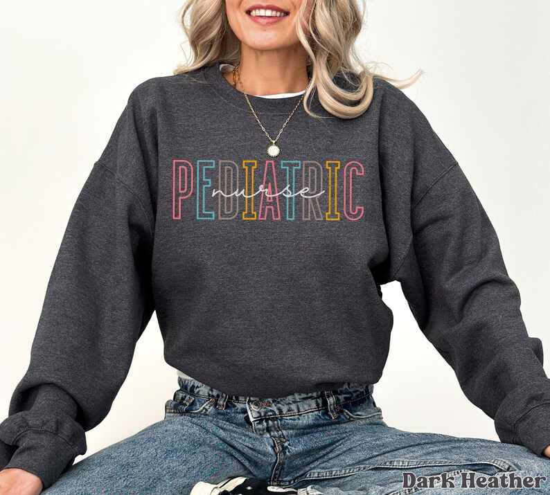 May include: Dark heather grey sweatshirt with the text "PEDIATRIC nurse" in rainbow colors.
